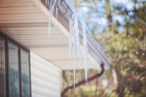 Ice,Dam,In,Gutter,And,Ice,Frozen,On,Roof,In